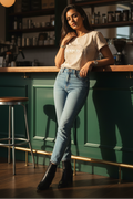 Woman leaning against a bar counter in a cozy cafe setting